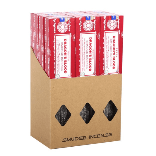 Box of Dragon's Blood incense sticks with three black stones on a white background