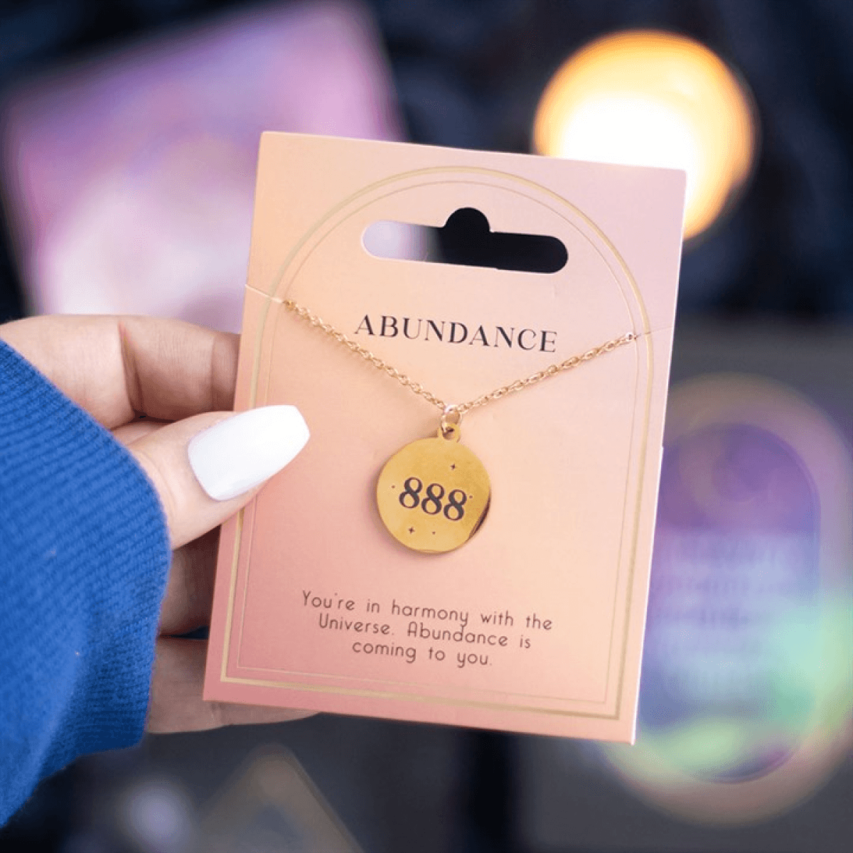 Hand holding 888 Angel Number Abundance Necklace on a card, showcasing divine guidance and spiritual abundance.