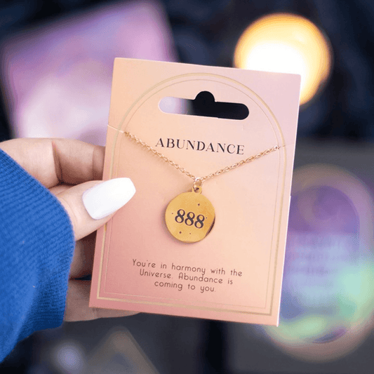 Hand holding 888 Angel Number Abundance Necklace on a card, showcasing divine guidance and spiritual abundance.