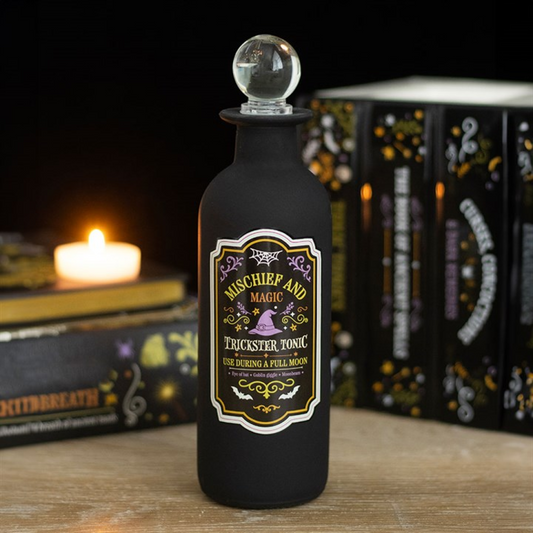 Decorative glass potion bottle labeled Mischief and Magic Trickster Tonic, ideal for Halloween decor.
