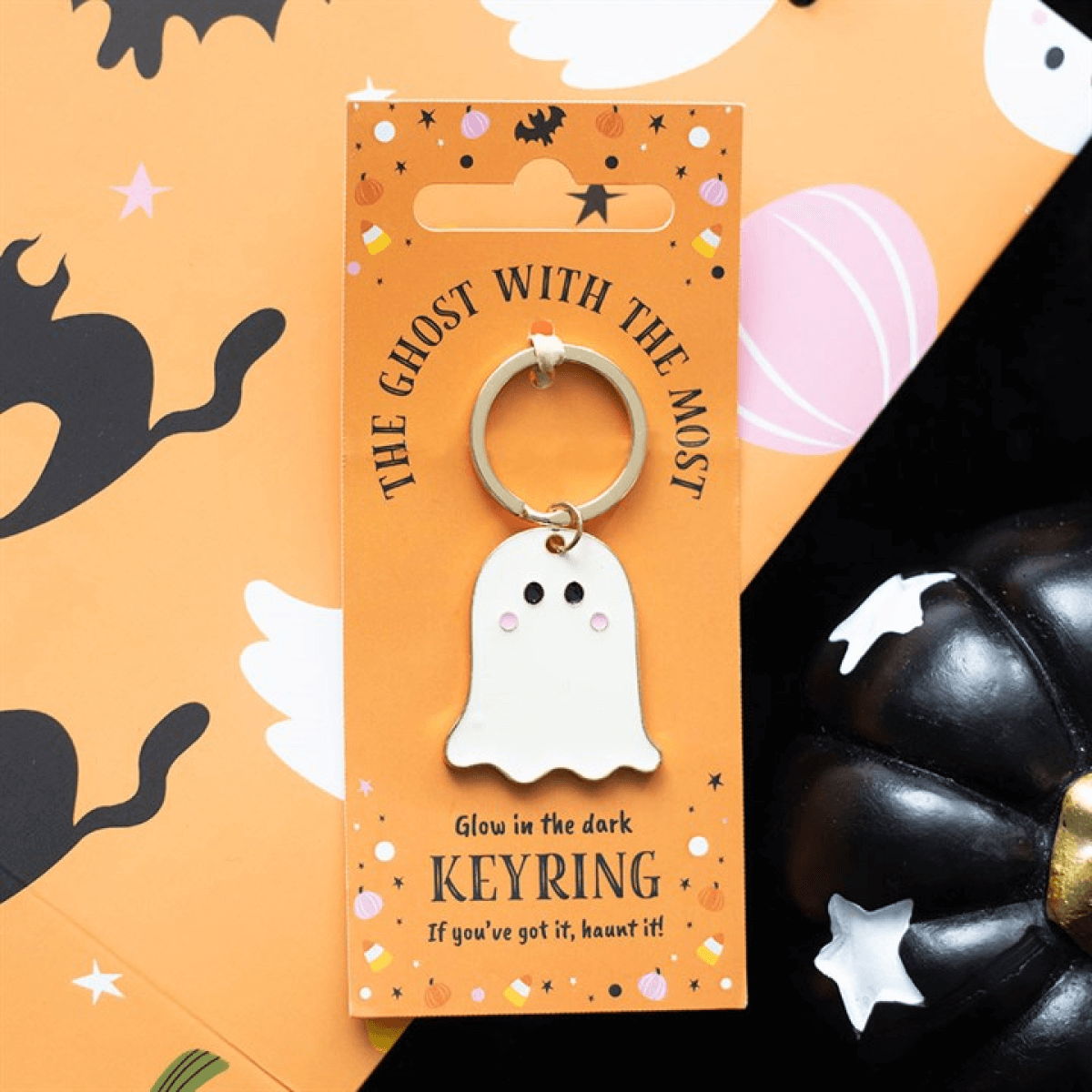 Glow-in-the-dark ghost keyring on an orange card with Halloween-themed design