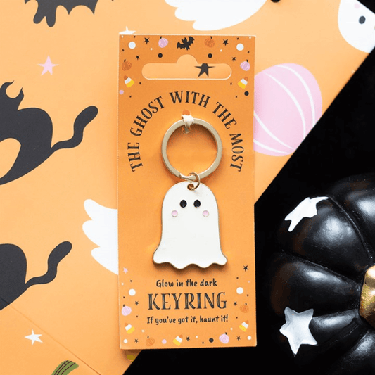 Glow-in-the-dark ghost keyring on an orange card with Halloween-themed design