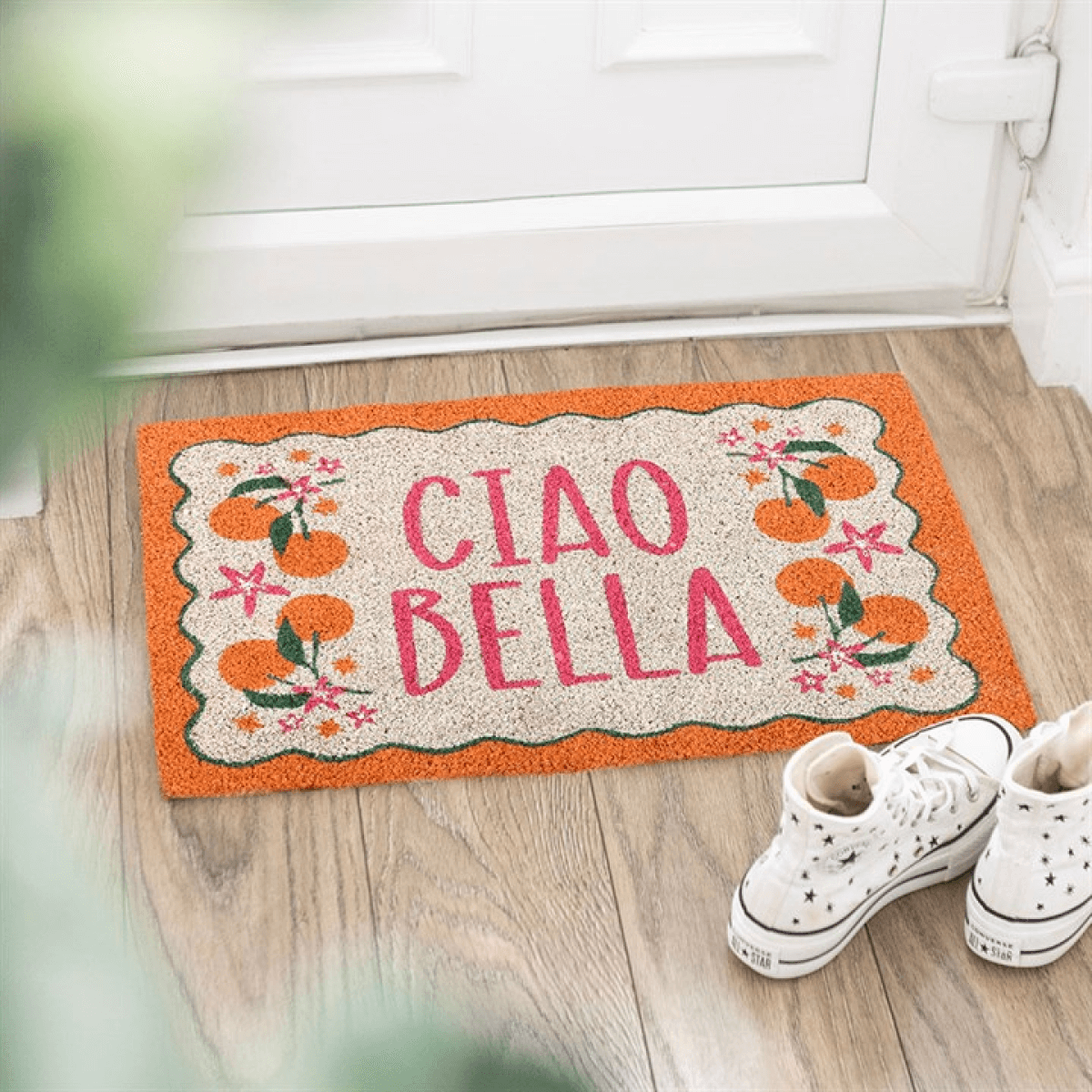 Ciao Bella Doormat with vibrant orange borders and citrus fruit design for cheerful entryways.