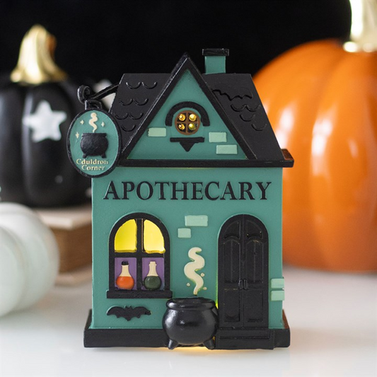 LED light up decoration of an Apothecary shop with glowing windows, perfect for Halloween displays.