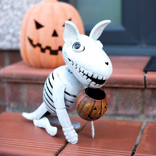 Metal skeleton dog ornament with pumpkin bucket for Halloween decorations.