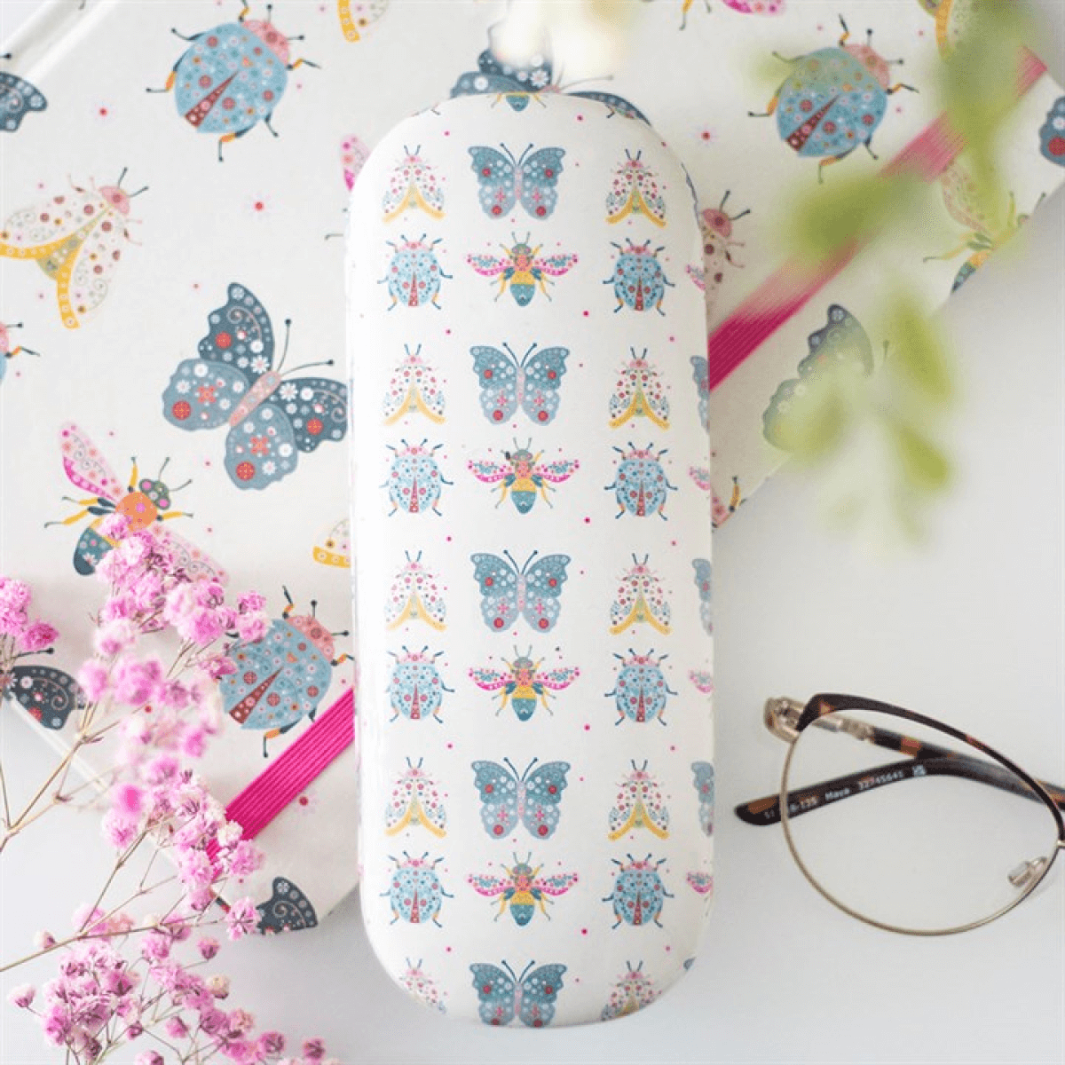 Eyeglass case with butterfly design on a floral background