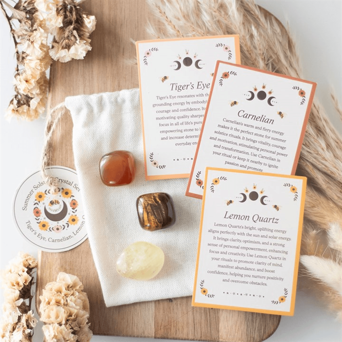 Crystal stones with informational cards on a wooden surface