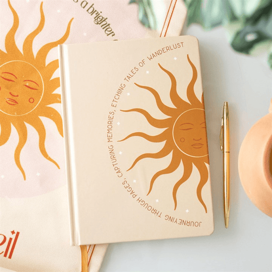 Notebook with sun design and text on a light background