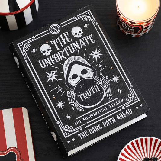 The Misfortune Teller Book Shaped Storage Box with mystical designs and ominous skulls.