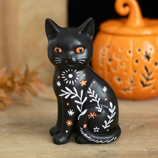 Folk-inspired black cat ornament with floral details, perfect seasonal decoration for home.