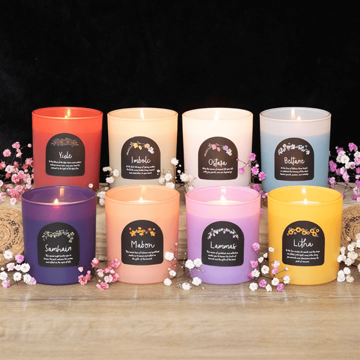 Set of 8 Wheel of the Year candles in colorful glass jars with cork lids, representing seasonal sabbats.