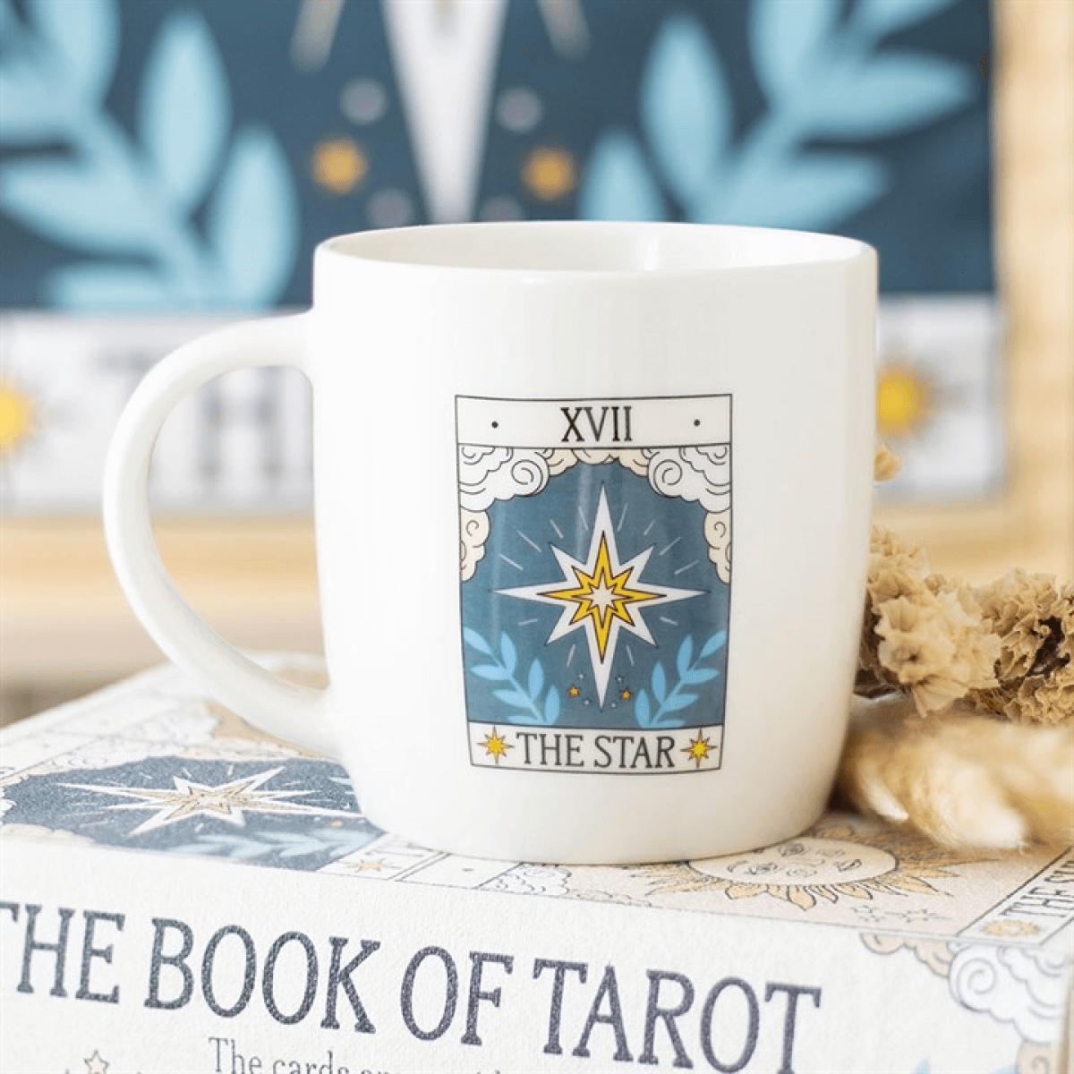 White mug with 'The Star' tarot card design on a book titled 'The Book of Tarot'.