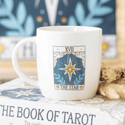 White mug with 'The Star' tarot card design on a book titled 'The Book of Tarot'.
